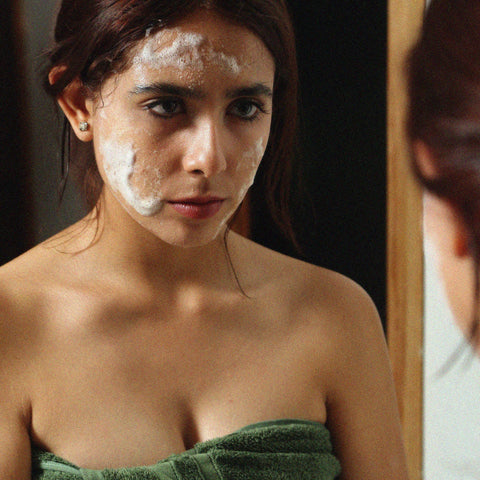Woman applying Temazcal Life bar soap to face. Temazcal Life bar soap botanical ingredients make it a mild face cleanser that doesn't dry skin.